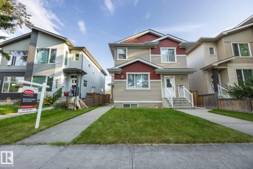 Traditional architectural style with red and beige siding, white trim, and a gabled roofline - 8952 81 Avenue Nw, Edmonton, AB 