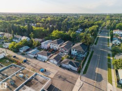 Residential street with detached homes and tree-lined surroundings - 