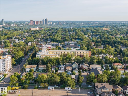 Expansive urban landscape with extensive tree canopy, diverse residential architecture, multistory apartment buildings, and distant city skyline - 8952 81 Avenue Nw, Edmonton, AB 