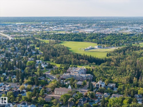 Expansive urban landscape featuring a mix of residential structures, mature tree coverage, and open green spaces - 8952 81 Avenue Nw, Edmonton, AB 