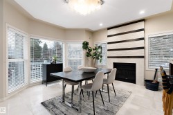 Bay windows with blinds, recessed lighting, tile flooring, stone-clad fireplace with wood accents, and a contemporary ceiling fixture - 