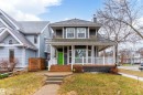 Gray-sided exterior with white trim and a green front door - 9654 100 Street Nw, Edmonton, AB 