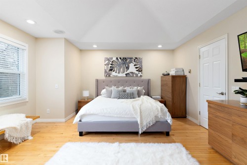 Recessed lighting, wood-finish flooring, white trim, and a white paneled door - 9654 100 Street Nw, Edmonton, AB 