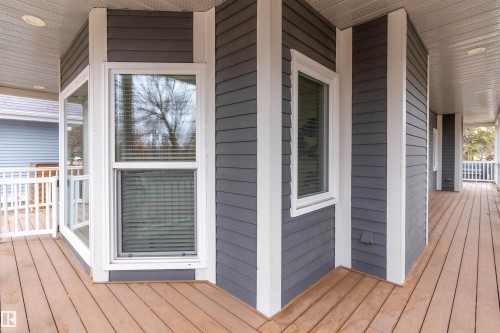 Expansive outdoor decking, durable siding exterior, multiple windows, white railings, and recessed ceiling lighting - 9654 100 Street Nw, Edmonton, AB 