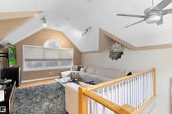 Vaulted ceiling with track lighting and ceiling fan - 