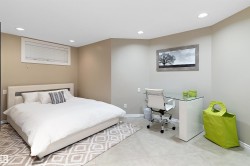 Recessed ceiling lighting, a window with horizontal blinds, and light-toned walls - 