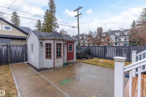 Detached shed with siding exterior, concrete patio, and fenced yard - 9654 100 Street Nw, Edmonton, AB 