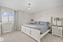 Neutral wall paint, light-toned carpeting, and a double window with a water backdrop - 