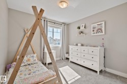 Carpeted flooring, neutral wall tones, recessed window, ceiling-mounted light fixture, and shelving - 