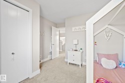Soft neutral wall paint with white trim, light-colored carpeting, and a white interior door - 