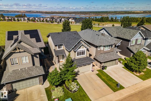Residential property with stone accenting, attached two-car garage, and established landscaping - 2096 Redtail Common Nw, Edmonton, AB 