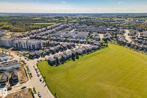 Residential neighborhood with diverse housing styles, adjacent green space, and multi-story apartment buildings - 2096 Redtail Common Nw, Edmonton, AB 