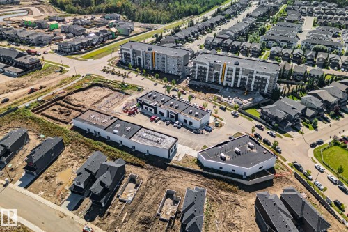 Developing neighborhood featuring a mix of residential housing, multi-unit apartment complexes, and commercial buildings - 2096 Redtail Common Nw, Edmonton, AB 