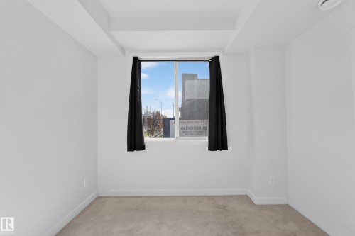 Carpeted flooring, white painted walls, and a large window - #58 16231 19 Av Sw, Edmonton, AB 