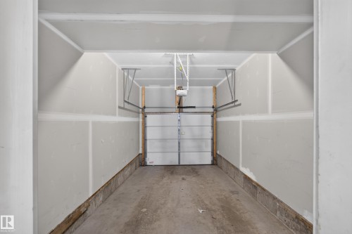 Attached garage with a sectional garage door - #58 16231 19 Av Sw, Edmonton, AB 