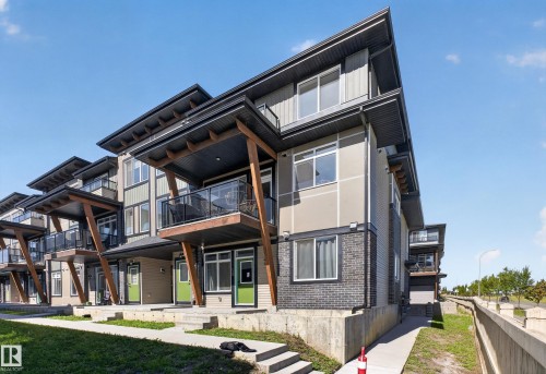 Contemporary multi-story exterior with horizontal siding, brick accents, and a distinctive flat roofline - #58 16231 19 Av Sw, Edmonton, AB 