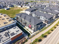 Multi-level construction with dark-pitched roofs - 