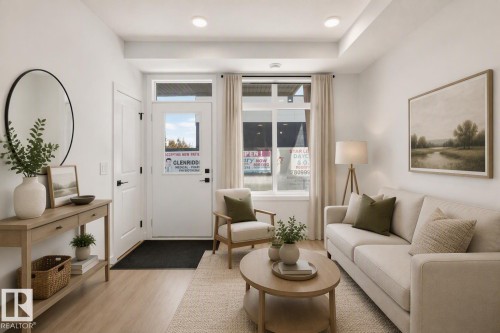 Recessed lighting, wood-finish flooring, white trim, and a glass-paneled entry door - #58 16231 19 Av Sw, Edmonton, AB 