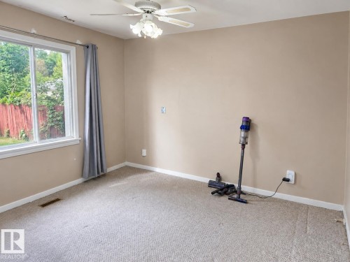 Neutral-toned wall paint, white trim, and light-colored carpeting - 12130 124 Street Nw, Edmonton, AB 