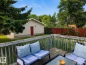 Expansive wood-plank deck with a perimeter railing - 12130 124 Street Nw, Edmonton, AB 