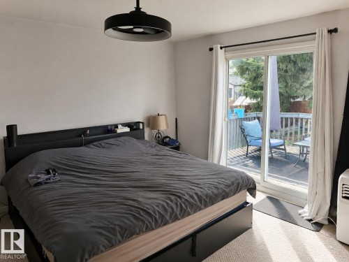 Sliding glass door leading to an outdoor deck - 12130 124 Street Nw, Edmonton, AB 