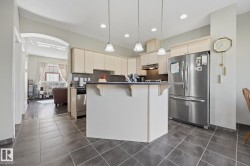 Kitchen featuring a peninsula island, stainless steel appliances, recessed lighting, and tiled flooring - 