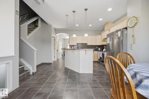 Kitchen with light-toned cabinetry and stainless steel appliances - #102 13825 155 Av Nw, Edmonton, AB 
