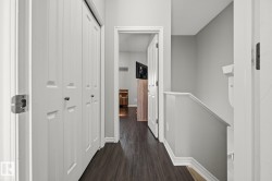 Dark wood-finish flooring with white trim - 