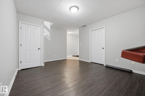 Wood-finish flooring with light gray walls and white trim - #102 13825 155 Av Nw, Edmonton, AB 