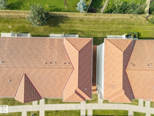 Terracotta-toned tile roofing across multiple structures - #102 13825 155 Av Nw, Edmonton, AB 