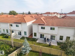 Terracotta tile roof, stucco exterior, rear patio, and a fenced yard - 