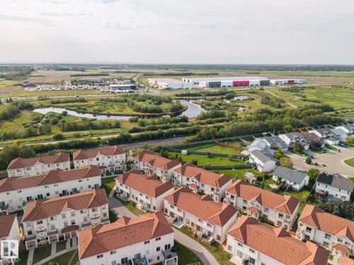 Red tile roofs and light-colored facades - #102 13825 155 Av Nw, Edmonton, AB 