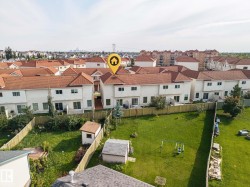 Townhouse with a private fenced backyard, multiple windows, and a red tile roof - 