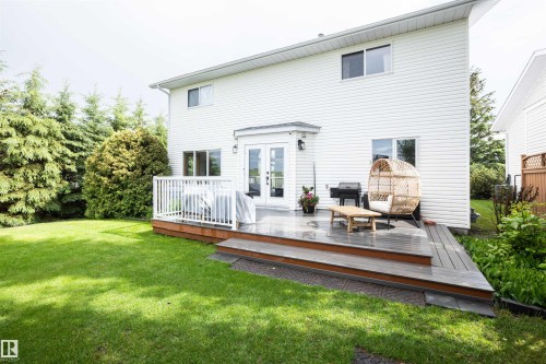 Spacious backyard featuring a multi-level deck with white railings - 5502 60 Avenue, Barrhead, AB - Outdoor With Exterior