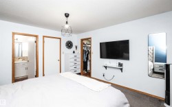 Bedroom featuring light-colored walls and carpeted flooring - 
