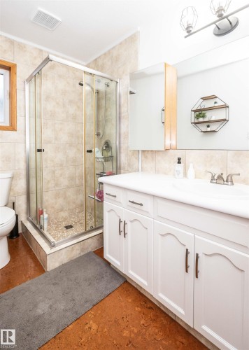 Bathroom featuring a white vanity with integrated sink, chrome faucet, and coordinating hardware - 5502 60 Avenue, Barrhead, AB - Indoor Photo Showing Bathroom