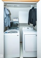 Dedicated laundry area featuring a top-loading washing machine and front-loading dryer - 