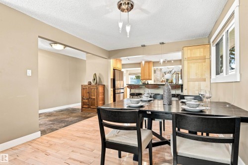 Hardwood-finish flooring, recessed lighting, and a window with white trim - 14307 50 Avenue Nw, Edmonton, AB 