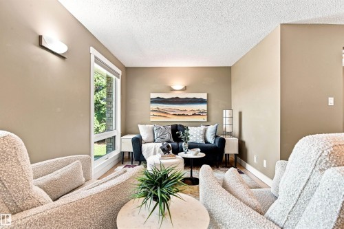 Neutral-toned walls, recessed lighting, and a large window with white trim - 14307 50 Avenue Nw, Edmonton, AB 