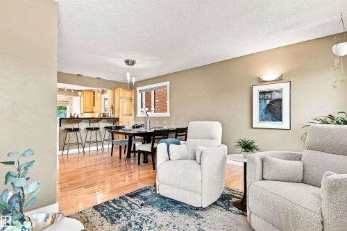 Hardwood flooring throughout, recessed lighting, and a breakfast bar with built-in cabinetry - 14307 50 Avenue Nw, Edmonton, AB 