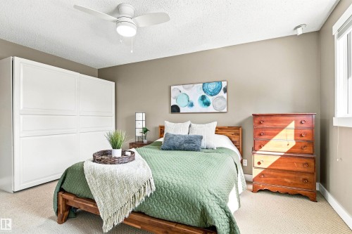 Recessed ceiling lighting, ceiling fan, carpet flooring, a window, and a built-in wardrobe with paneling - 14307 50 Avenue Nw, Edmonton, AB 