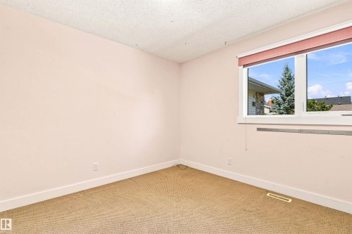Single casement window with a light-colored frame - 14307 50 Avenue Nw, Edmonton, AB 