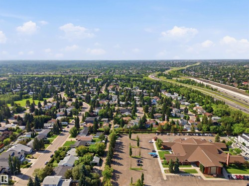 Expansive suburban landscape featuring extensive tree coverage, residential streets, and a prominent highway - 14307 50 Avenue Nw, Edmonton, AB 