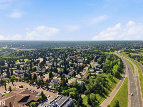 Aerial perspective of a residential area with extensive tree coverage and a multi-lane highway - 14307 50 Avenue Nw, Edmonton, AB 