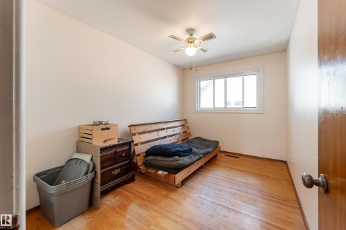 Hardwood flooring, white painted walls, white window trim, and a ceiling fan with light fixture - 14906 76 Avenue Nw, Edmonton, AB 