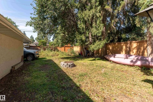 Lawn area featuring a brick-lined fire pit - 14906 76 Avenue Nw, Edmonton, AB 