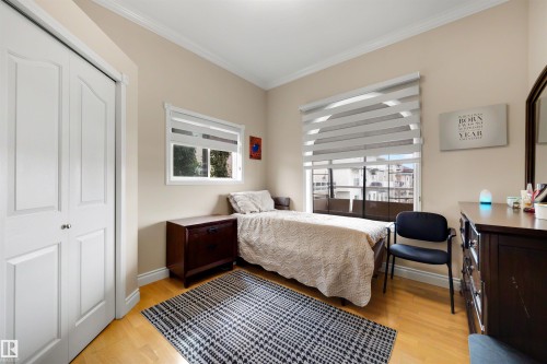 Light wood-finish flooring with white trim and crown molding - 282 Ozerna Road Nw, Edmonton, AB 