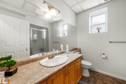 Vanity with wood-finish cabinetry, integrated sink, and laminate countertop - 