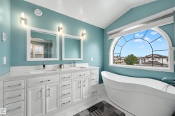 Dual vanity with white cabinetry and integrated sinks - 