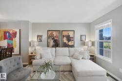 Recessed lighting, wood-finish flooring, and a large window with white trim - 